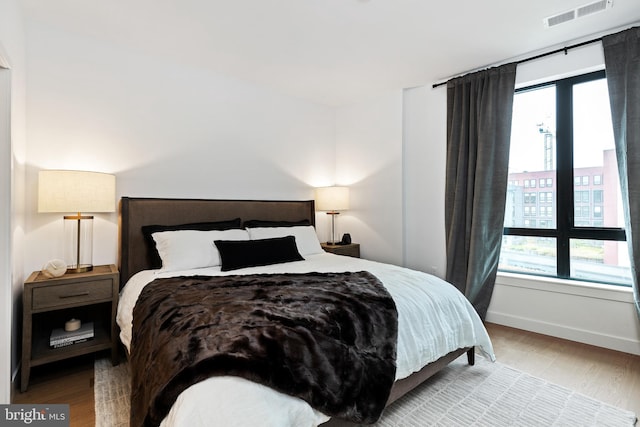 7175 12th St NW Unit 517, Washington, DC 20011 - bedroom featuring wood finished floors and baseboards