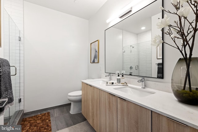 7175 12th St NW Unit 517, Washington, DC 20011 - bathroom with toilet, double vanity, a shower stall, baseboards, and wood finished floors