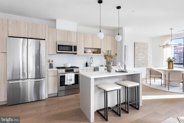 7175 12th St NW Unit 517, Washington, DC 20011 - kitchen featuring stainless steel appliances, light countertops, modern cabinets, and light brown cabinetry