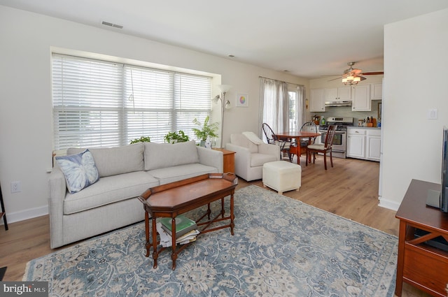 2404 Stokes Rd, Mount Laurel, NJ 08054 - living room with light wood-style floors, ceiling fan, and baseboards