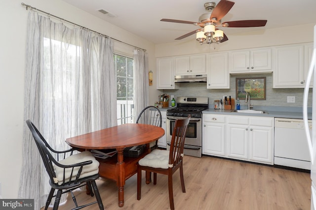 2404 Stokes Rd, Mount Laurel, NJ 08054 - kitchen featuring stainless steel gas stove, a sink, dishwasher, under cabinet range hood, and backsplash