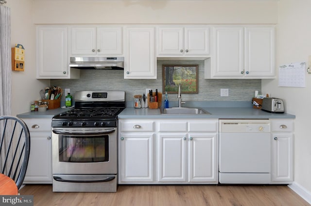 2404 Stokes Rd, Mount Laurel, NJ 08054 - kitchen featuring stainless steel gas stove, dishwasher, under cabinet range hood, a sink, and white cabinets