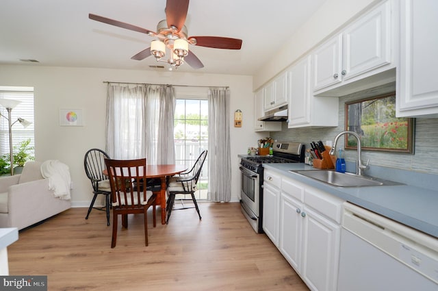 2404 Stokes Rd, Mount Laurel, NJ 08054 - kitchen featuring stainless steel range with gas stovetop, white dishwasher, under cabinet range hood, a sink, and white cabinetry