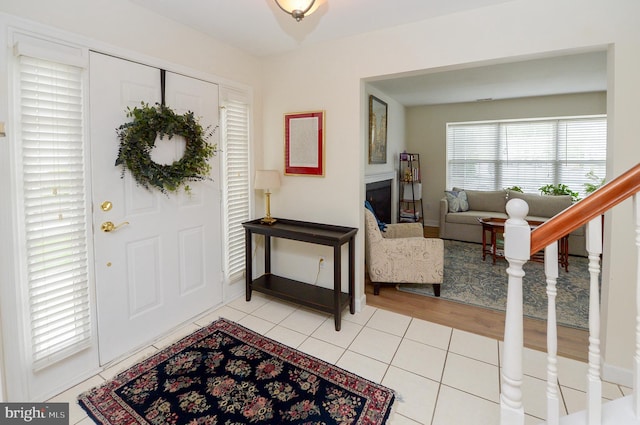 2404 Stokes Rd, Mount Laurel, NJ 08054 - foyer with light tile patterned floors, a fireplace, and baseboards