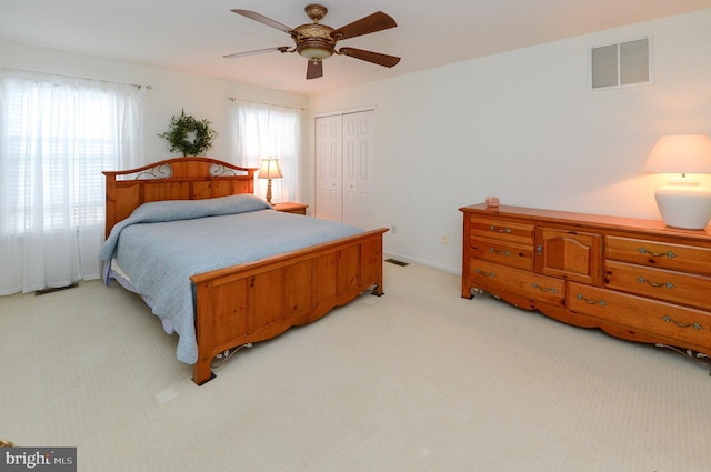 2404 Stokes Rd, Mount Laurel, NJ 08054 - bedroom with multiple windows, light colored carpet, a closet, and a ceiling fan