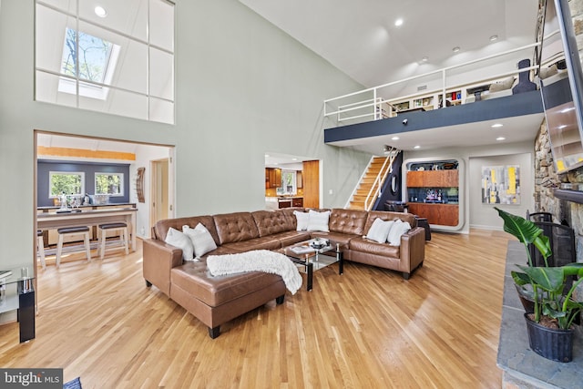8901 Potomac Station Ln, Potomac, MD 20854 - living room with wood finished floors, stairway, a high ceiling, a fireplace, and recessed lighting