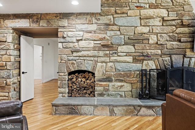 8901 Potomac Station Ln, Potomac, MD 20854 - living room with a stone fireplace, wood finished floors, and baseboards