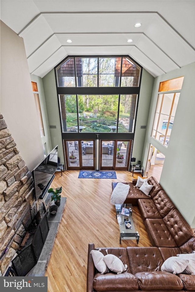 8901 Potomac Station Ln, Potomac, MD 20854 - living room featuring lofted ceiling, wood finished floors, and healthy amount of natural light