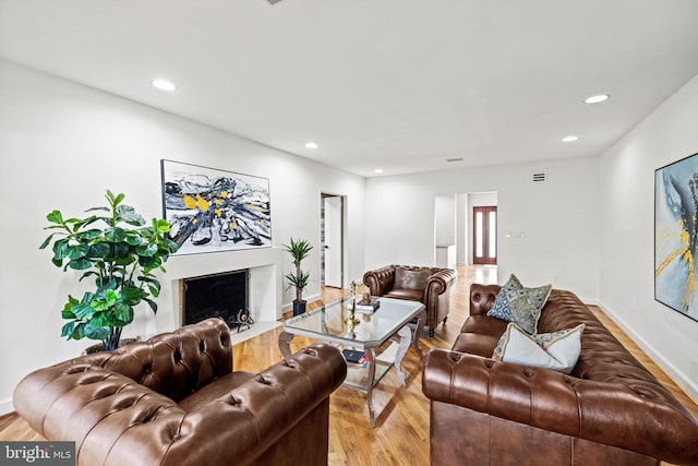 8901 Potomac Station Ln, Potomac, MD 20854 - living area with light wood-style flooring, recessed lighting, a high end fireplace, and baseboards