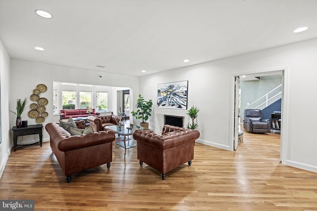 8901 Potomac Station Ln, Potomac, MD 20854 - living area with light wood-style floors, recessed lighting, a fireplace, and baseboards