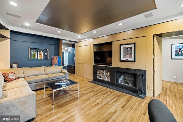 8901 Potomac Station Ln, Potomac, MD 20854 - living area featuring wood finished floors, a tray ceiling, recessed lighting, a fireplace with flush hearth, and baseboards