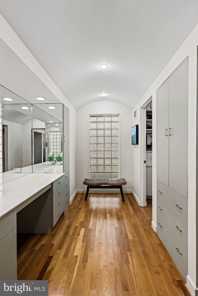 8901 Potomac Station Ln, Potomac, MD 20854 - bathroom featuring wood finished floors, baseboards, lofted ceiling, vanity, and recessed lighting