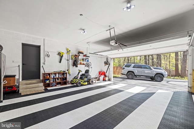 8901 Potomac Station Ln, Potomac, MD 20854 - garage featuring a garage door opener and concrete block wall