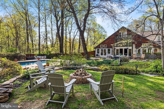 8901 Potomac Station Ln, Potomac, MD 20854 - view of yard featuring a fire pit, an outdoor pool, and a patio