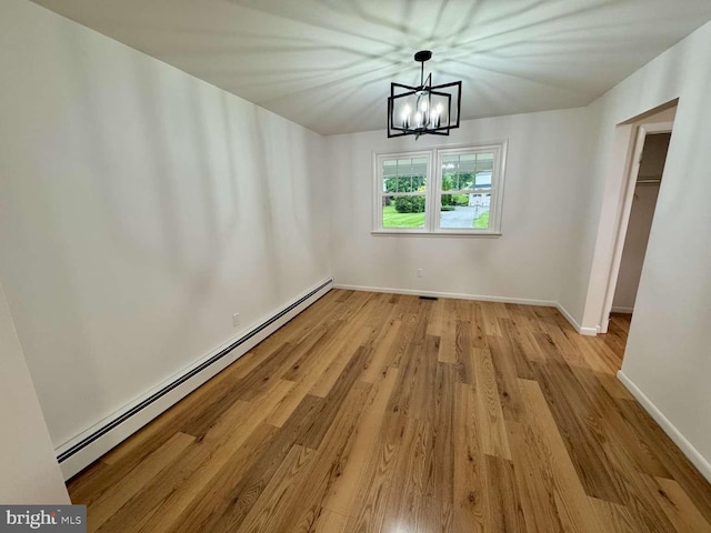 127 Homestead Dr, Doylestown, PA 18901 - unfurnished dining area featuring a baseboard heating unit, a chandelier, wood finished floors, and baseboards