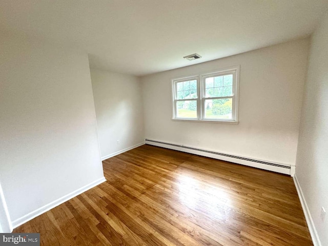 127 Homestead Dr, Doylestown, PA 18901 - empty room with a baseboard heating unit, wood finished floors, and baseboards