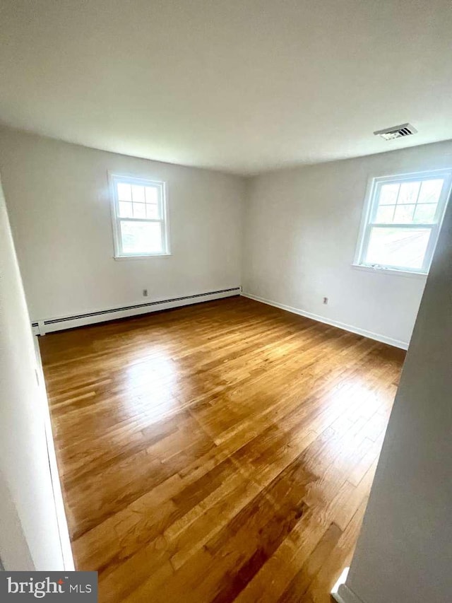 127 Homestead Dr, Doylestown, PA 18901 - empty room with baseboard heating, wood finished floors, and baseboards