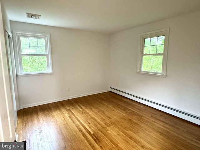 127 Homestead Dr, Doylestown, PA 18901 - unfurnished room with baseboard heating, healthy amount of natural light, wood finished floors, and baseboards