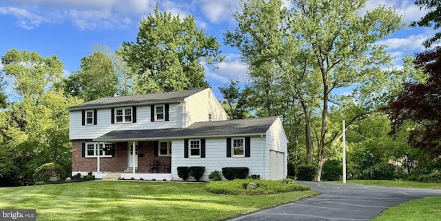 127 Homestead Dr, Doylestown, PA 18901 - view of front of home featuring driveway, covered porch, a front lawn, an attached garage, and view of scattered trees