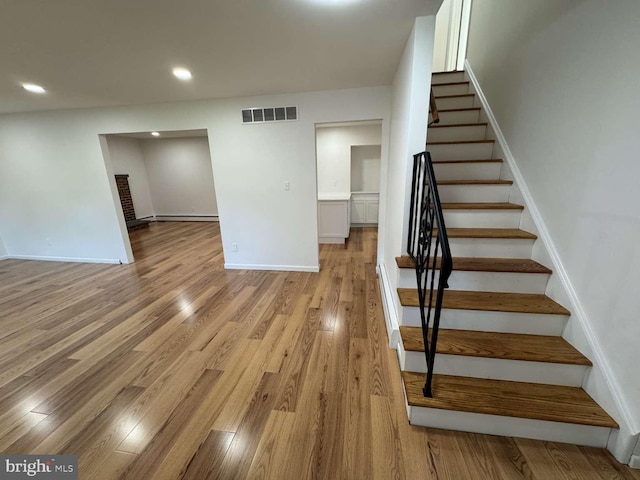127 Homestead Dr, Doylestown, PA 18901 - stairs with baseboards, wood finished floors, a baseboard radiator, and recessed lighting