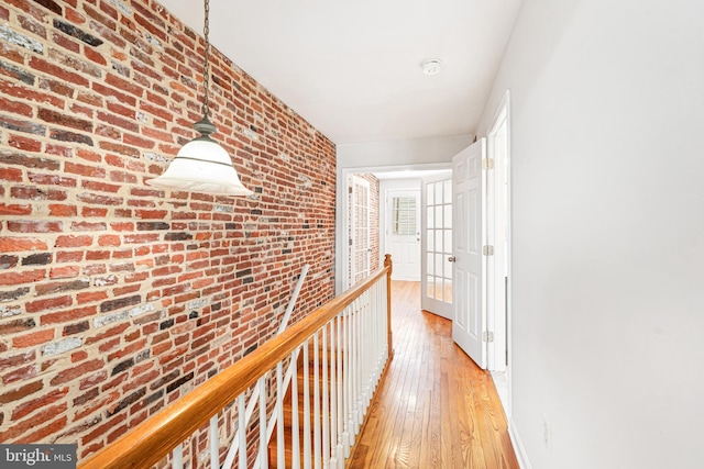 1622 E Clement St, Baltimore, MD 21230 - hallway featuring light wood-style flooring, brick wall, and baseboards