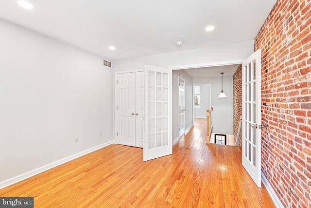 1622 E Clement St, Baltimore, MD 21230 - corridor featuring an upstairs landing, brick wall, light wood finished floors, baseboards, and recessed lighting
