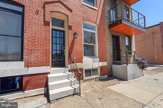 1622 E Clement St, Baltimore, MD 21230 - property entrance with brick siding and a balcony