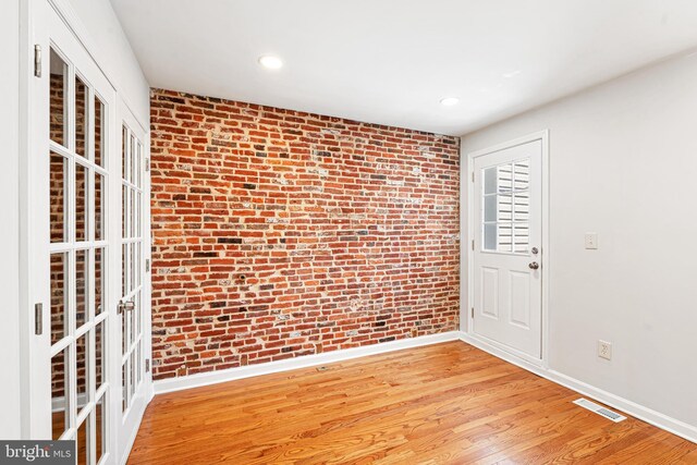 1622 E Clement St, Baltimore, MD 21230 - foyer entrance featuring brick wall, baseboards, light wood finished floors, and recessed lighting