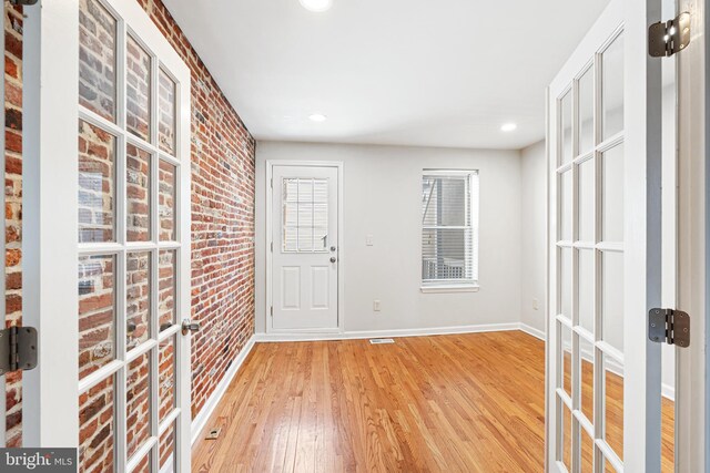 1622 E Clement St, Baltimore, MD 21230 - foyer with brick wall, wood finished floors, baseboards, and recessed lighting