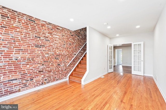1622 E Clement St, Baltimore, MD 21230 - spare room featuring french doors, baseboards, hardwood / wood-style floors, brick wall, and recessed lighting