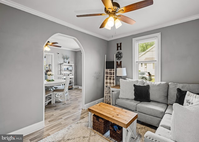 1200 Hessian Ave, National Park, NJ 08063 - living room featuring ceiling fan, arched walkways, baseboards, ornamental molding, and light wood-style flooring
