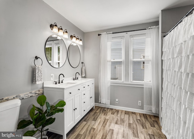 1200 Hessian Ave, National Park, NJ 08063 - bathroom with double vanity, toilet, baseboards, and wood finished floors