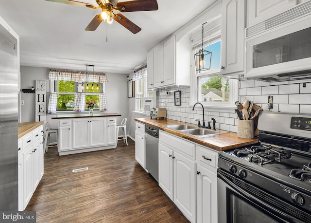 1200 Hessian Ave, National Park, NJ 08063 - kitchen featuring stainless steel appliances, wooden counters, a sink, ceiling fan, and dark wood-type flooring
