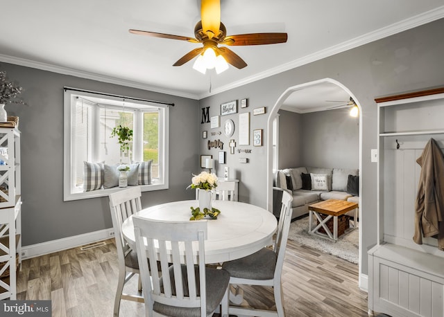 1200 Hessian Ave, National Park, NJ 08063 - dining area featuring a ceiling fan, light wood-type flooring, arched walkways, baseboards, and ornamental molding