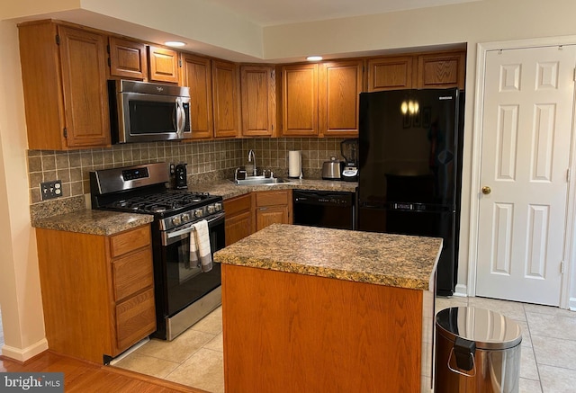 15496 Travailer Ct, Woodbridge, VA 22193 - kitchen with black appliances, a sink, tasteful backsplash, and brown cabinetry