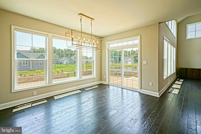 33557 Downing Cir, Lewes, DE 19958 - unfurnished dining area featuring a chandelier and dark wood-type flooring