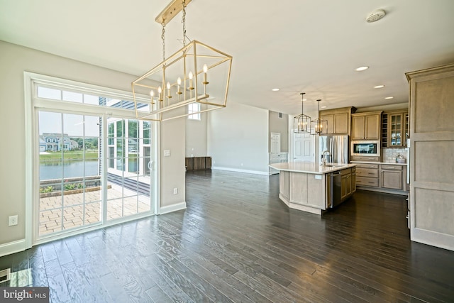 33557 Downing Cir, Lewes, DE 19958 - kitchen with appliances with stainless steel finishes, a chandelier, light countertops, a center island with sink, and glass insert cabinets