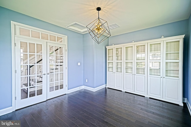 33557 Downing Cir, Lewes, DE 19958 - unfurnished dining area featuring french doors, dark wood-style flooring, and a chandelier