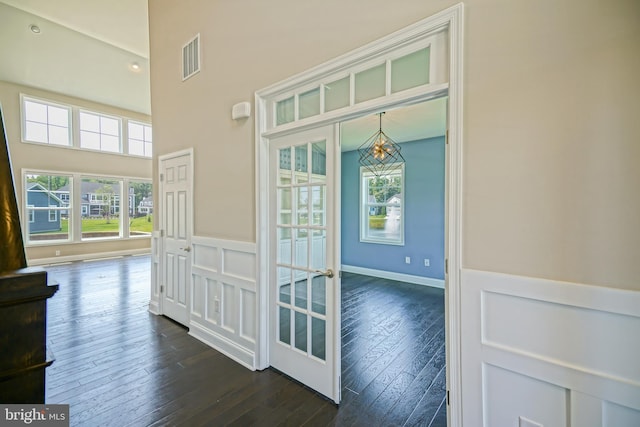 33557 Downing Cir, Lewes, DE 19958 - hall featuring a chandelier, dark wood finished floors, and a towering ceiling