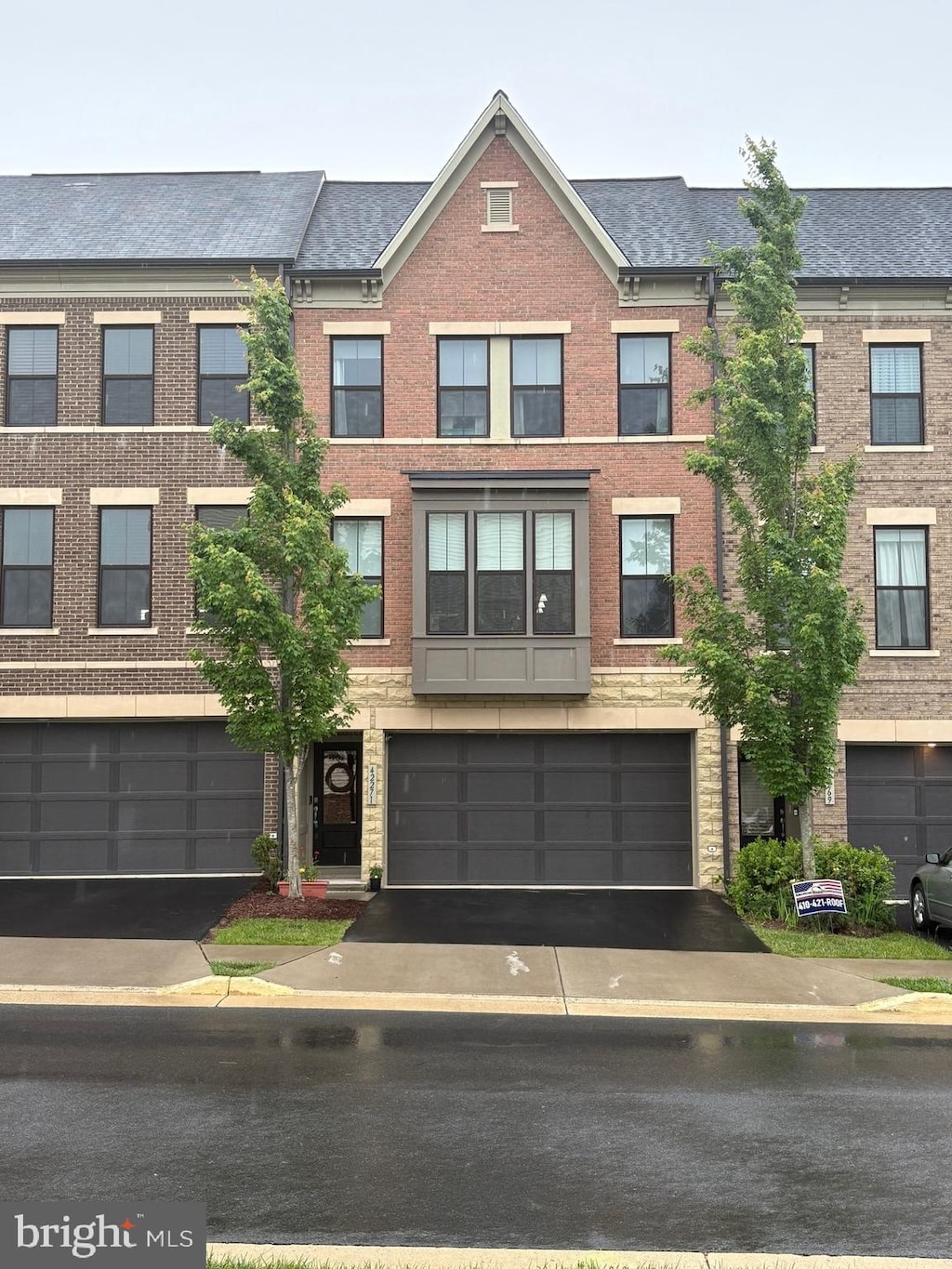 42271 Otter Creek Ter, Ashburn, VA 20148 - townhome / multi-family property with driveway and brick siding