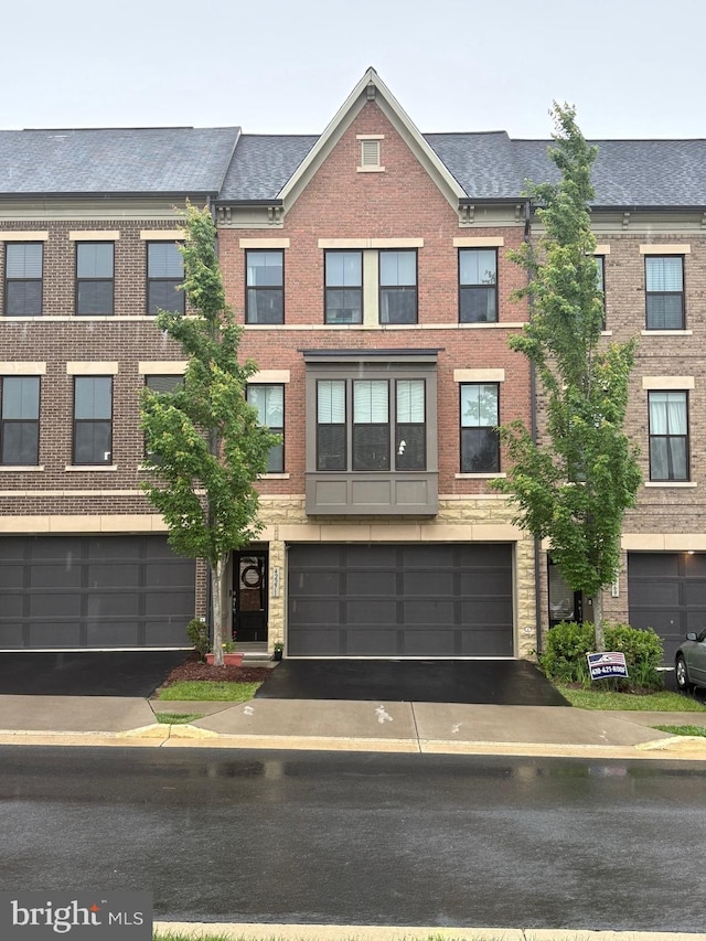 42271 Otter Creek Ter, Ashburn, VA 20148 - townhome / multi-family property with driveway and brick siding