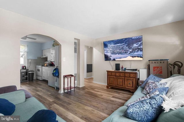 1326 Pine Grove Ave, Baltimore, MD 21237 - living room with arched walkways, wood finished floors, and baseboards