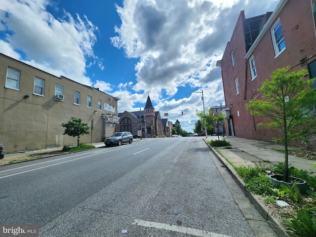 1431 E Preston St, Baltimore, MD 21213 - view of asphalt road featuring curbs, sidewalks, street lights, and a residential view