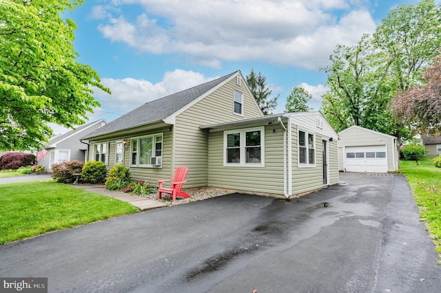 1230 Whitehall Ave, Easton, PA 18045 - view of front of home with a detached garage, an outbuilding, asphalt driveway, a front lawn, and cooling unit