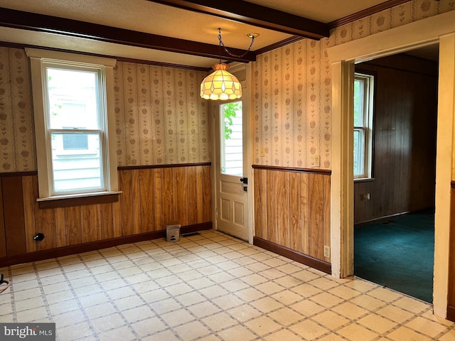221 S State St, Talmage, PA 17580 - unfurnished dining area featuring wainscoting, beam ceiling, wallpapered walls, light flooring, and baseboards