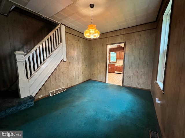 221 S State St, Talmage, PA 17580 - carpeted spare room featuring stairway, wooden walls, and baseboards