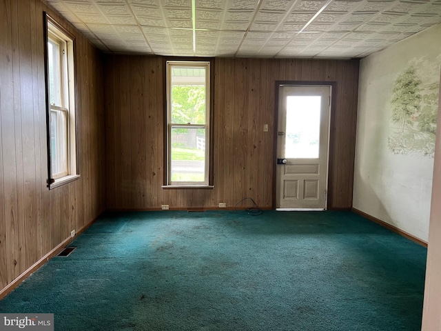 221 S State St, Talmage, PA 17580 - spare room with healthy amount of natural light, carpet, an ornate ceiling, wood walls, and baseboards