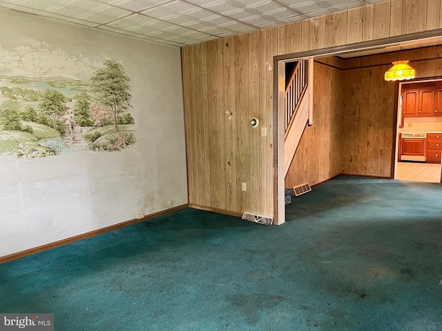 221 S State St, Talmage, PA 17580 - spare room featuring wood walls, carpet flooring, stairs, and baseboards