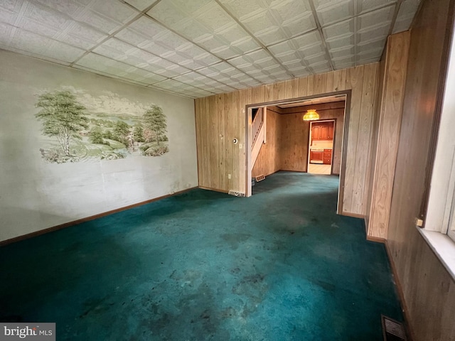221 S State St, Talmage, PA 17580 - spare room featuring wood walls, dark carpet, and baseboards