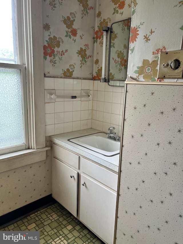 221 S State St, Talmage, PA 17580 - bathroom with wallpapered walls, vanity, tile walls, and wainscoting